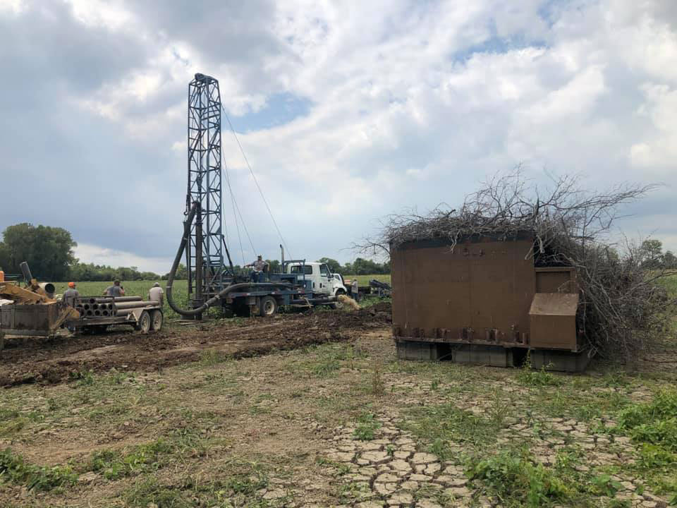 Drill truck drilling in a field. Drill truck drilling in a field.