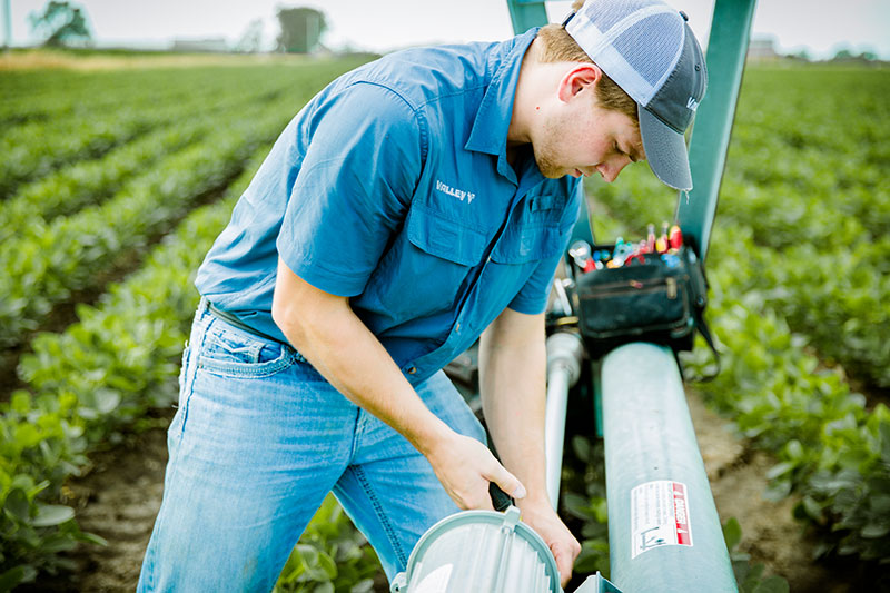 Service technician working on a Valley center pivot. Service technician working on a Valley center pivot.